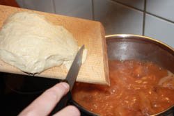 Dumpling into Hungarian bean soup